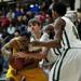 Huron players try to strip the ball from Ypsilanti senior Jalen Harmon during the game on Friday, March 8. Daniel Brenner I AnnArbor.com